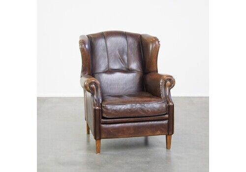 Comfortable And Sturdy Wing Chair Made Of Sheepskin And Neatly Finished With Black Piping