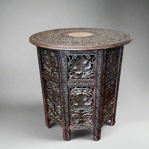 An Intricately Carved Anglo Indian Hardwood Folding Table With Profuse Carving And Brass Inlay