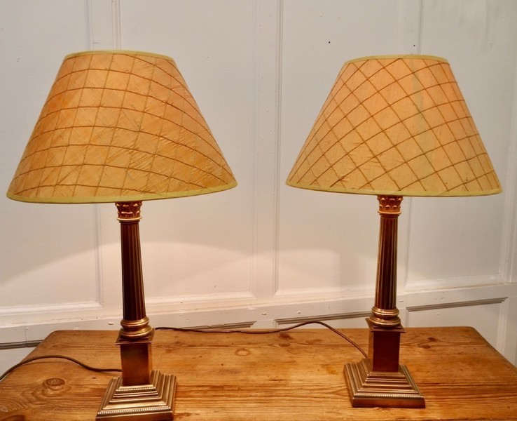 A Pair Of Brass Corinthian Column Table Lamps With Shades